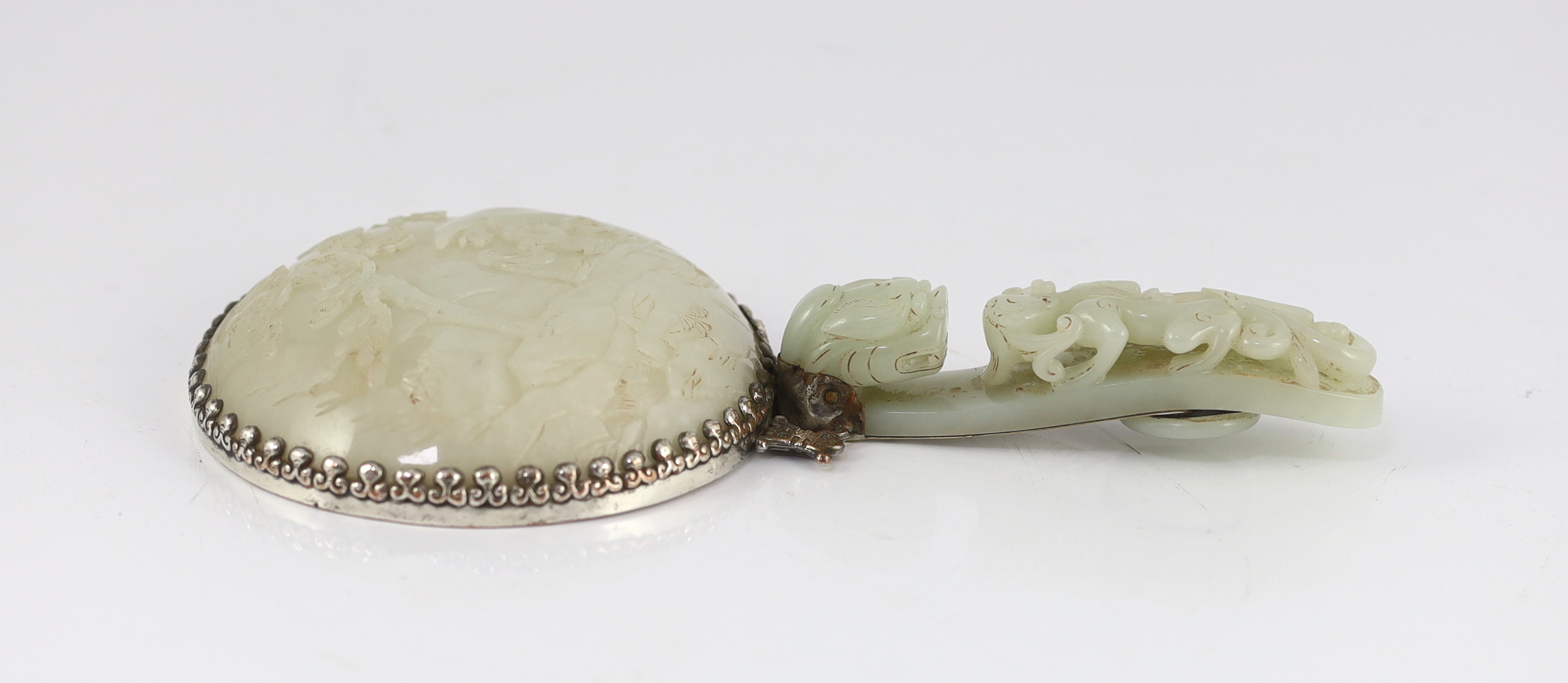 An early 20th century Chinese plated hand mirror with 18th/19th century jade mounts